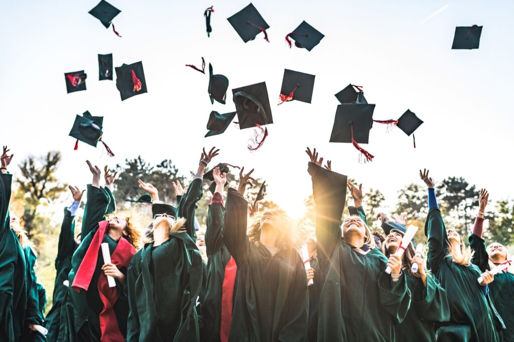 Picture of students graduating and throwing their caps in the air
